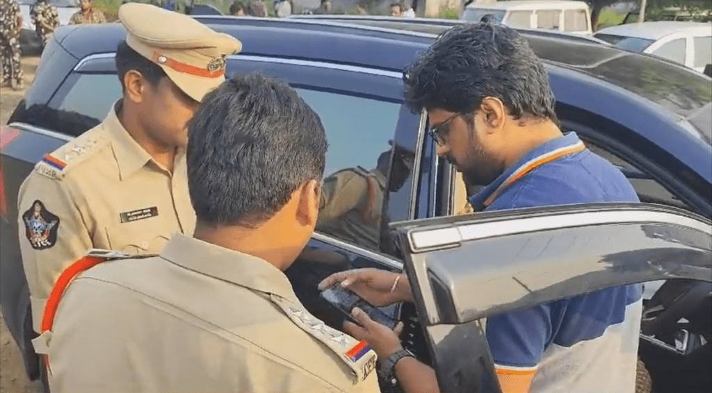 Indian policeman holding mobile phone against civilian during controversial verification moment