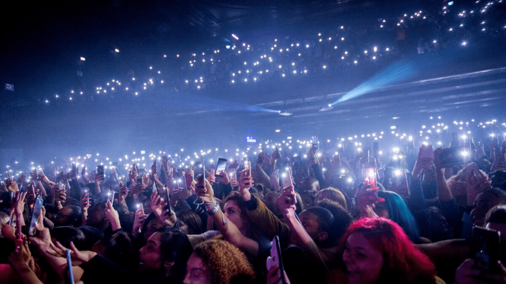 Crowd filming performance as live show instantly spreads online