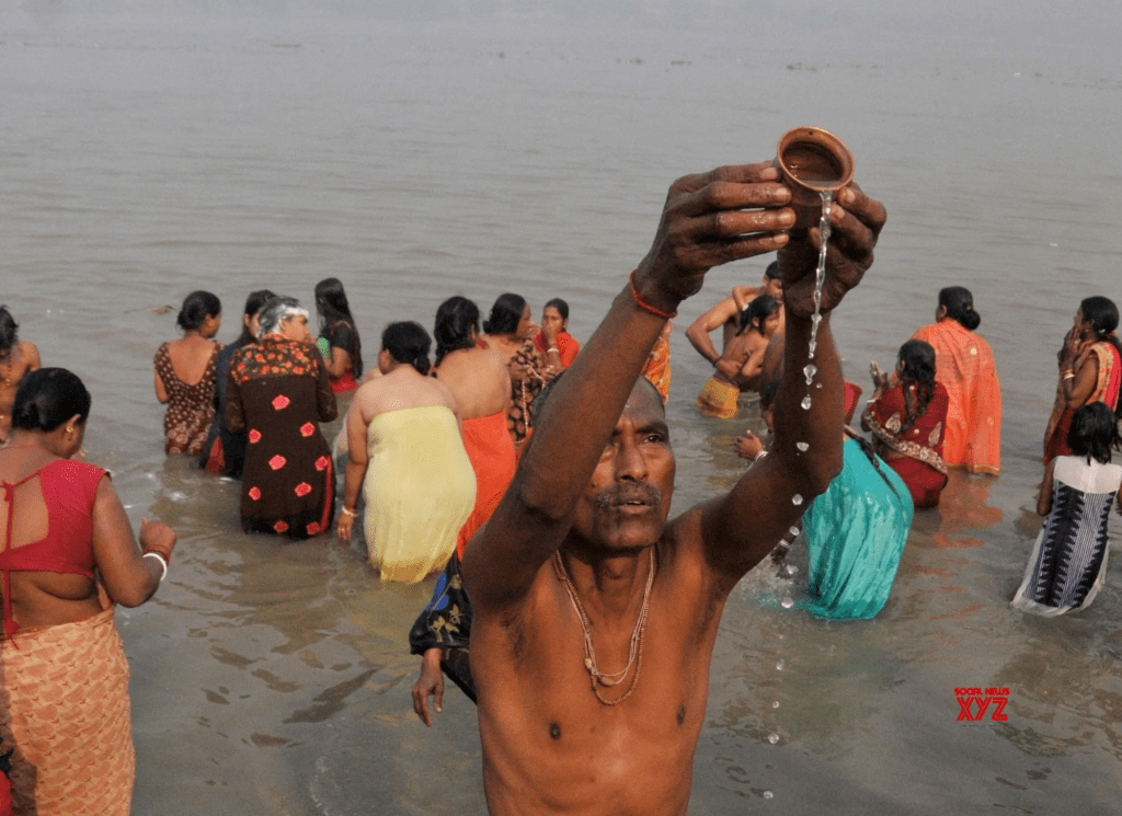 Sacred river bath at sunrise marking auspicious Sankranti observance