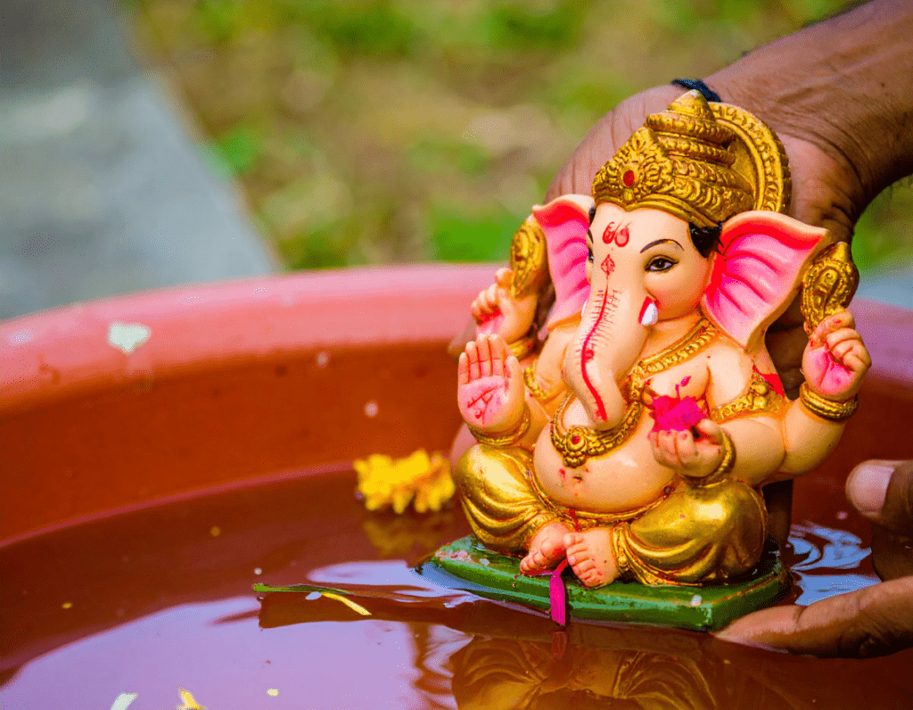 Devotees immersing Ganpati idol symbolising detachment and continuity