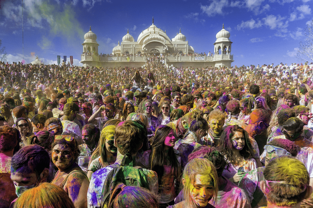Holi celebration showing people embracing despite differences and shared colour