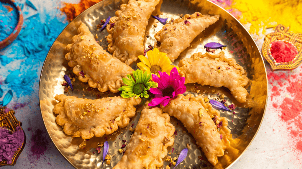 Traditional gujiya sweets prepared and shared during Holi celebrations